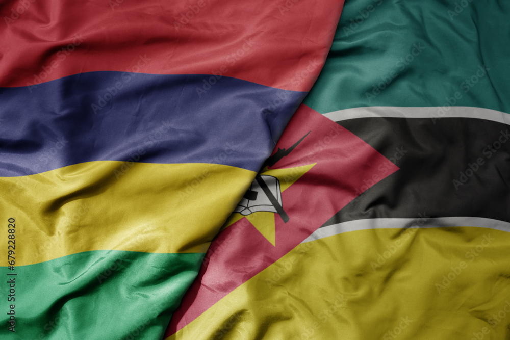 Obraz premium big waving national colorful flag of mauritius and national flag of mozambique .