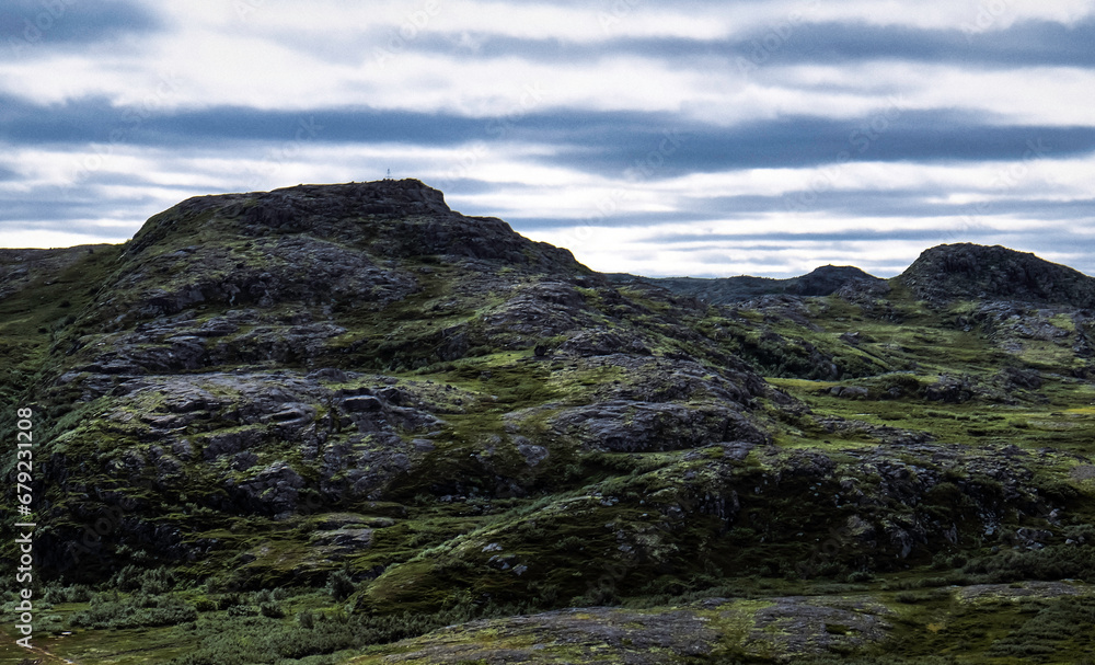 Gloomy rocky hill of polar tundra, Teriberka. Northern nature of Kola Peninsula