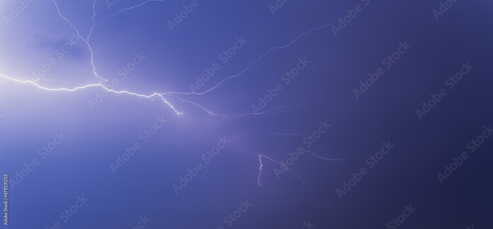 Fototapeta premium Lightning from the black and blue sky. Storm clouds.