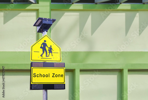 Fotografi LED solar cell warning flashing orange light with traffic security school sign o