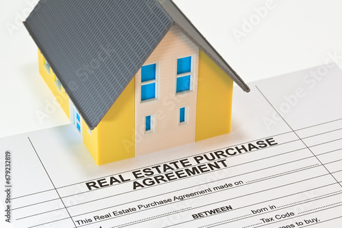 Real Estate Purchase Agreement concept with residential home model