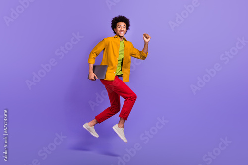 Full length profile side photo of crazy nice cheerful man wear stylish clothes hurry office isolated on purple color background