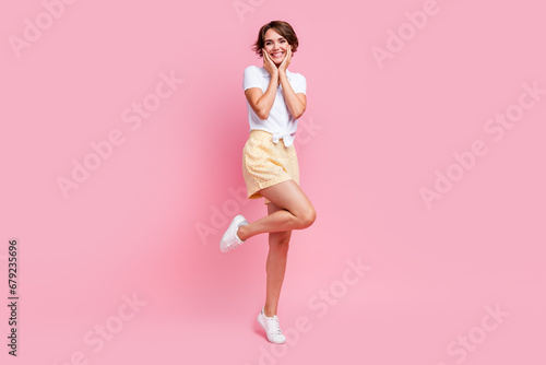 Full length photo of dreamy sweet young girl hands touch cheeks good mood stunning model in summer clothes isolated on pink color background