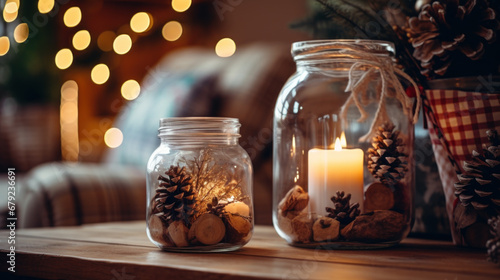 Cozy Christmas decor with candle in jar and pinecones. photo