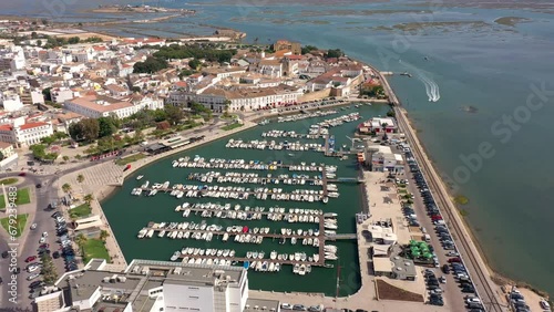 Aerial drone video of the harbor for boats in the marina of the city of Faro. Moving to the side. Portugal Algarve.