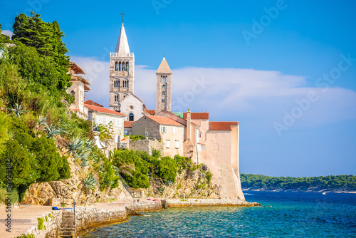 Historic town of Rab towers and beach walkway view