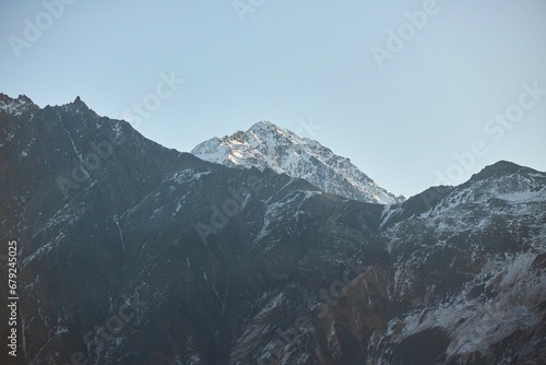 A mountain range at dawn. Snow on the slopes. Landscape
