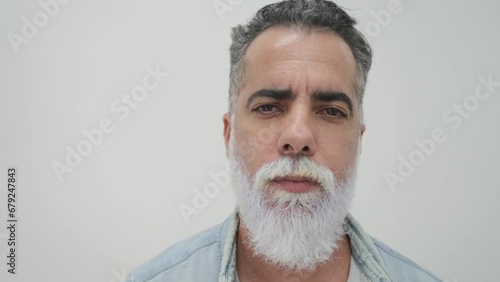 African middle-aged man with white dyed beard smirking at camera_2.MOV photo