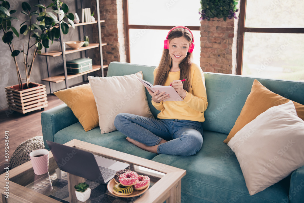 Portrait of satisfied friendly nice schoolgirl with long hairstyle wear stylish sweatshirt make homework writing in copybook at home Portrait of satisfied friendly nice schoolgirl with long hairstyle wear stylish sweatshirt make homework writing in copybook at home