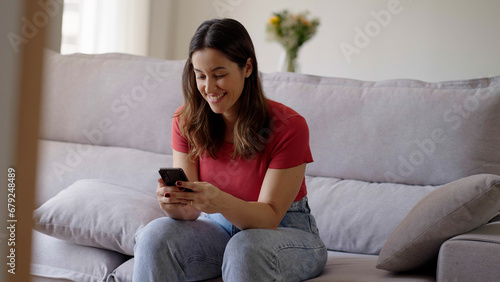 Woman using smartphone. Happy caucasian female enjoy online chat, internet purchase, browse web, download new cool freeware application. Modern wireless tech user concept 
 photo