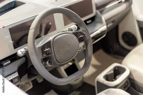 Modern car interior with steering wheel © dechevm
