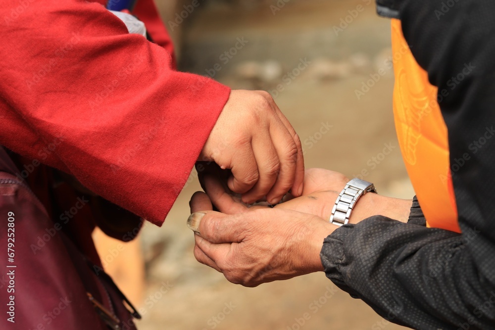 Kid helping a homeless person giving him a money