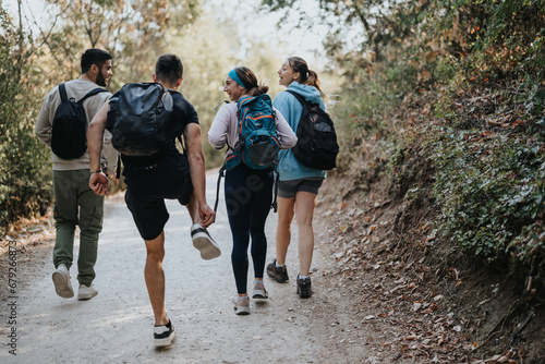 A group of friends hiking in the forest, enjoying conversations and the natural environment on a sunny day. Perfect for adventure travel and healthy outdoor activities.
