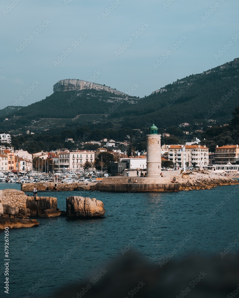 Scenic view of Cassis Lighthouse with the cityscape and mountains in the background. France