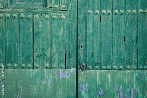 Detail of an old green wooden door. Lorenzana, León, Spain. photo