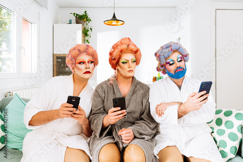 Photography Drag queens using phones in a living room