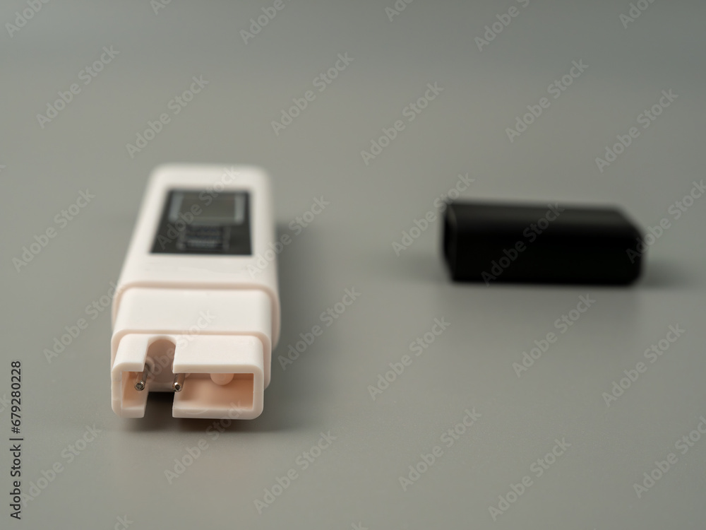 Water quality tester on a gray background. Device for measuring water quality. Water quality tester on a gray background. Device for measuring water quality.