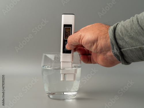 Water quality tester on a gray background. Device for measuring water quality. photo