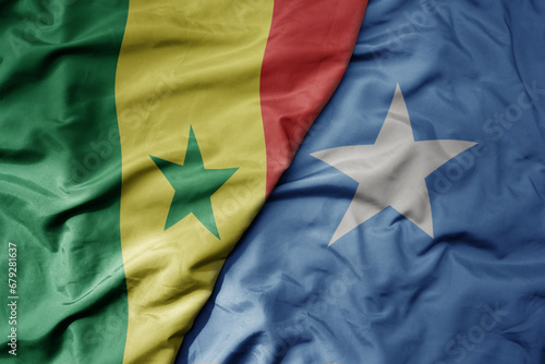 big waving national colorful flag of senegal and national flag of somalia
