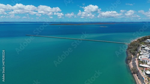 Aerial footage of Urangan pier and cars driving on Esplanade road in Urangan, QLD, Australia photo
