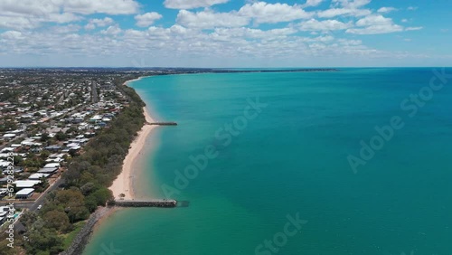 High drone footage of the stone piers on the sandy shore of Hervey Bay in Urangan, QLD, Australia photo