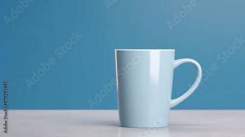 Simple white mug on a table with a matching blue background, minimalist design