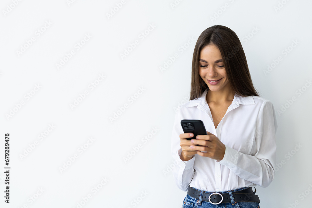 Portrait of a smiling woman holding smartphone over white background Portrait of a smiling woman holding smartphone over white background