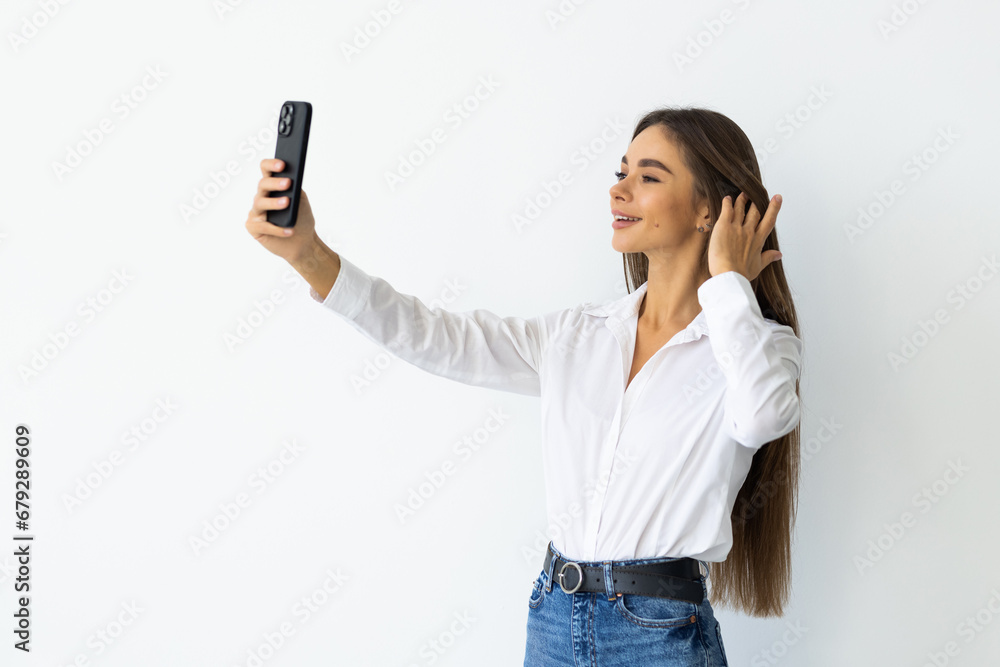 Portrait of woman making selfie photo on smartphone isolated on a white background Portrait of woman making selfie photo on smartphone isolated on a white background