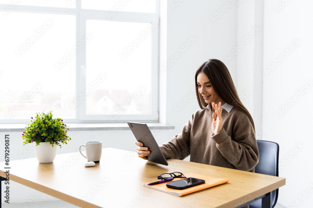 Young business woman working with tablet in corporate office Young business woman working with tablet in corporate office