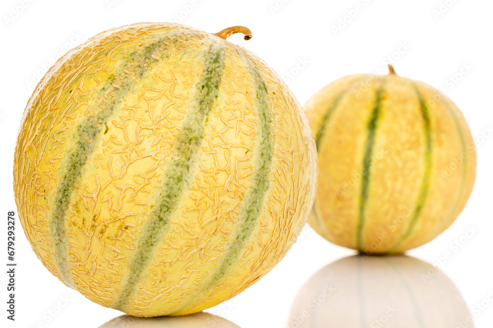 Two sweet cantaloupe melons, macro, isolated on white background.