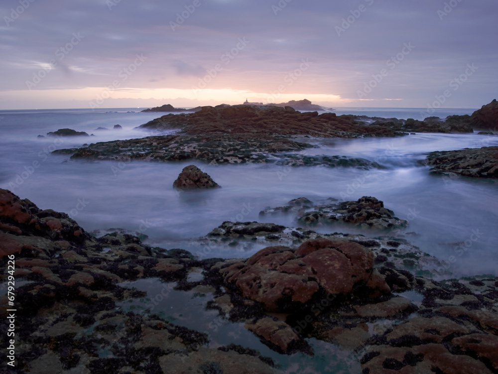 Rocky sea beach at dusk