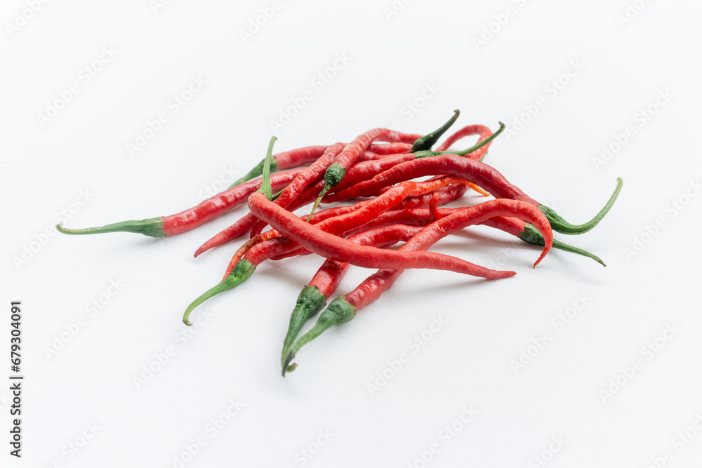 Indonesian best quality red hot chilies. A bunch of fresh curly red chilies isolated on white background. In Indonesia, it is commonly called Cabai Merah Keriting. Indonesian best quality red hot chilies. A bunch of fresh curly red chilies isolated on white background. In Indonesia, it is commonly called Cabai Merah Keriting.