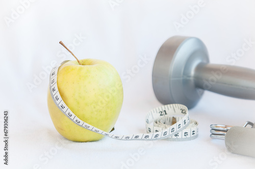 Measuring tape and Apple isolated on white background. Healthy lifestyle.
