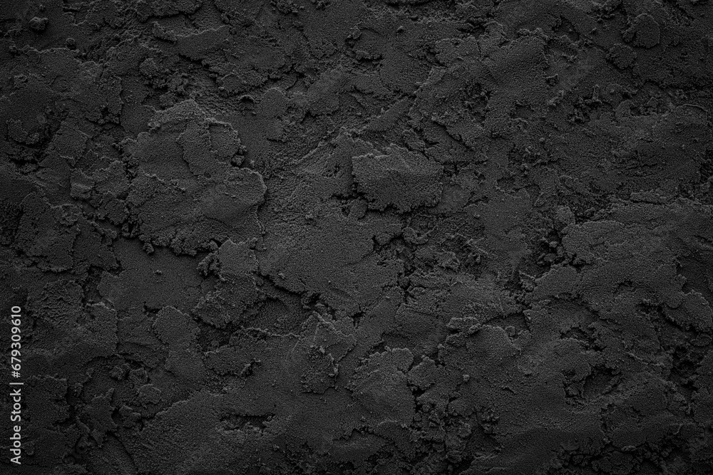 Black or dark gray rough grainy stone or sand plaster texture background Black or dark gray rough grainy stone or sand plaster texture background