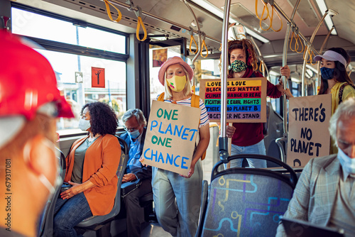 Activists with Protest Signs on Climate Change Riding a Bus photo
