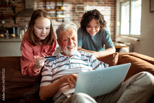 Grandfather and Grandkids online shopping together at home photo