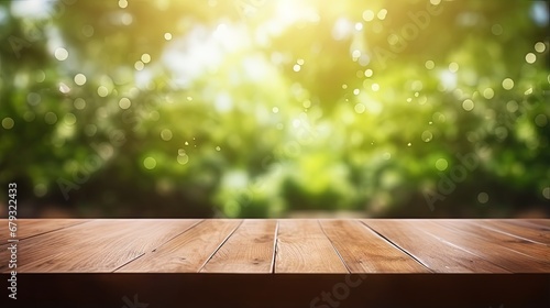 Empty wood table and defocused bokeh and blur background of garden trees with sunlight. product display template.