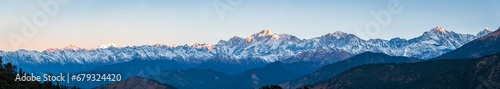 Panoramic view during sunset over snow cladded gangotri group mountain peaks falls in Greater Himalayas mountain range from Chopta  Uttarakhand  India.