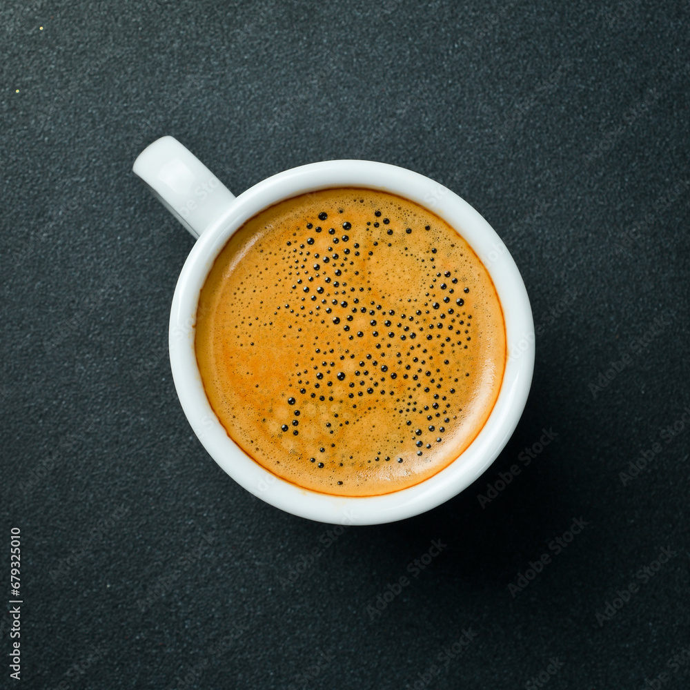 A cup of fragrant arabica or robusta coffee. Espresso. Top view, on a black background. Natural coffee. A cup of fragrant arabica or robusta coffee. Espresso. Top view, on a black background. Natural coffee.