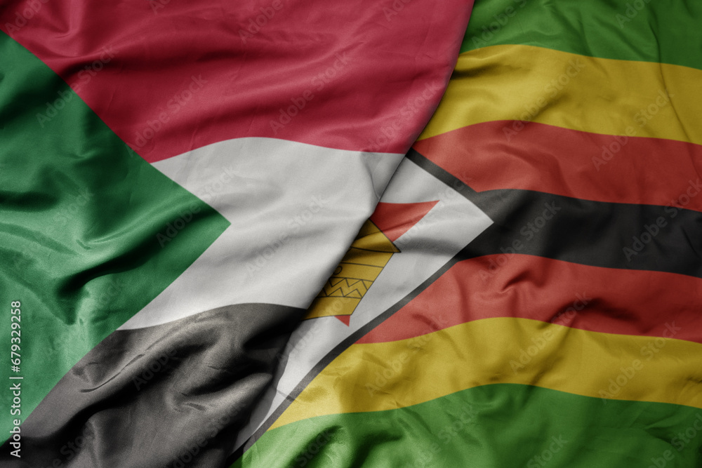 Obraz premium big waving national colorful flag of sudan and national flag of zimbabwe .