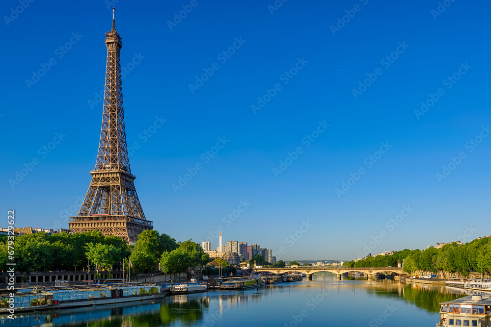 Fototapeta premium View of Eiffel Tower and river Seine at sunrise in Paris, France. Eiffel Tower is one of the most iconic landmarks of Paris