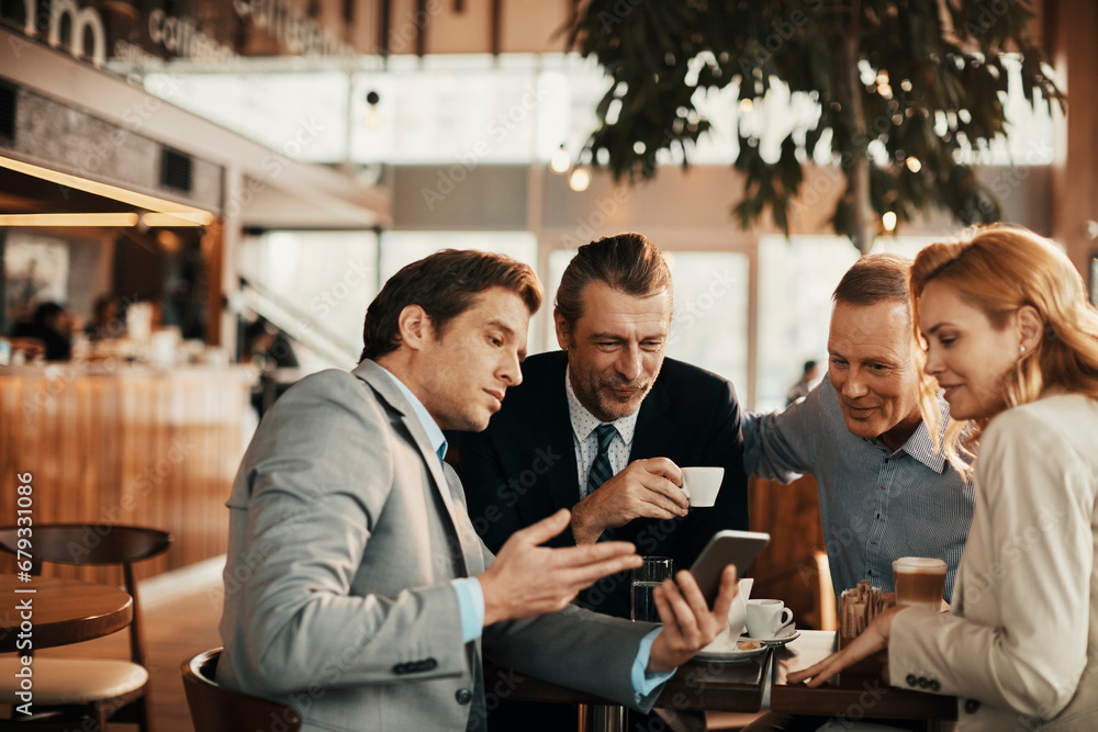 Colleagues Enjoying a Laugh During a Coffee Meeting Colleagues Enjoying a Laugh During a Coffee Meeting