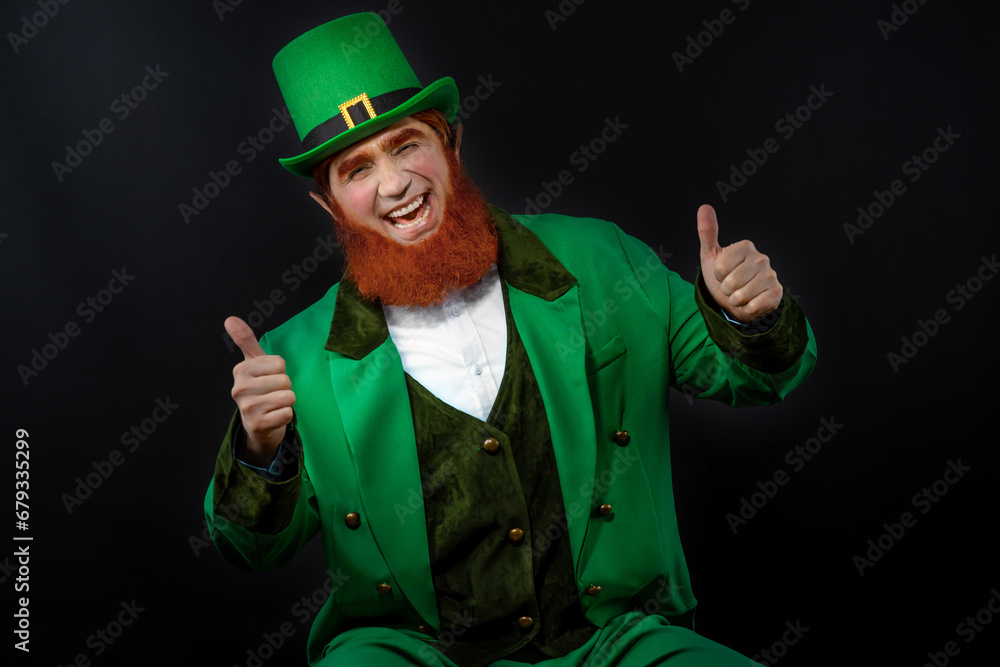 Leprechaun elf on St. Patrick's Day. Cheerful character Irish leprechaun for advertising with a red natural beard in a green suit and green hat for advertising. Cosplay at the festival on March 17th Leprechaun elf on St. Patrick's Day. Cheerful character Irish leprechaun for advertising with a red natural beard in a green suit and green hat for advertising. Cosplay at the festival on March 17th