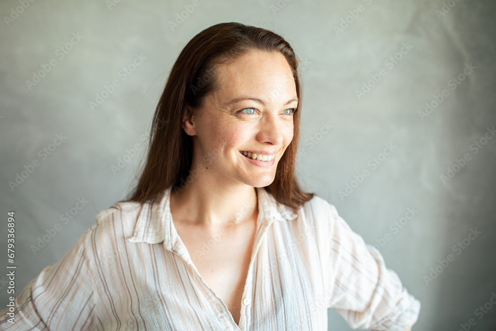 Confident Woman Standing Against a Textured Grey Confident Woman Standing Against a Textured Grey