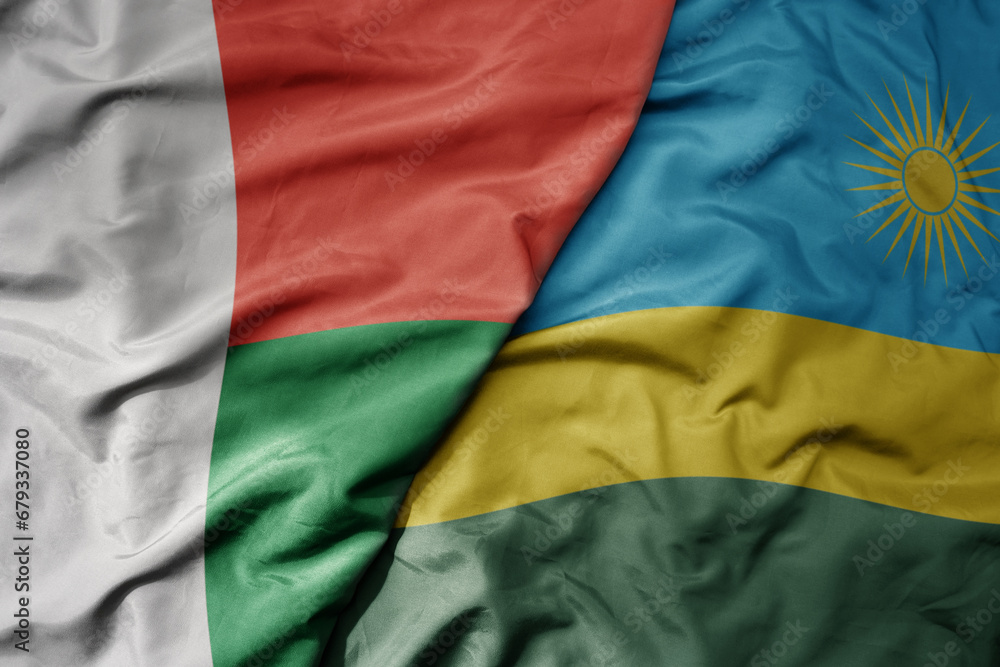 Obraz premium big waving national colorful flag of madagascar and national flag of rwanda .