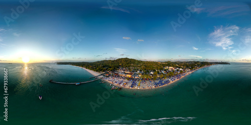 Imagem aérea em 360 graus da Praia de São Tomé de Paripe, localizada na cidade de Salvador, no estado da Bahia, em um final de tarde de um feriado. photo