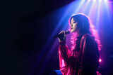 Beautiful Korean K-pop female singer singing romantic ballad music on live stage while holding microphone in retro pink and blue light with copy space