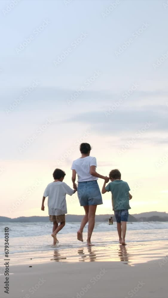 Immerse yourself in the enchantment of a beachside sunset with a joyful family—mom, kids, and dad—casting magical silhouettes, reaching for the sun. Witness the realization of children's dreams Immerse yourself in the enchantment of a beachside sunset with a joyful family—mom, kids, and dad—casting magical silhouettes, reaching for the sun. Witness the realization of children's dreams