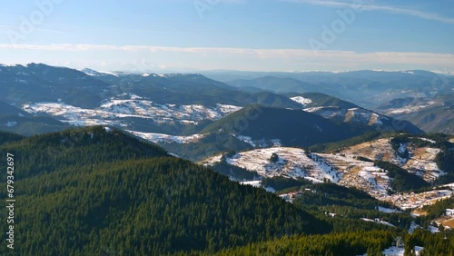 Pamporovo winter resort from the top. Mountain ridges over blue sky with spruce forest in the foreground and layers of hills. Macedonian Pine (Pinus peuce) grow on slopes at Snezhanka peak, Rhodopi mo photo