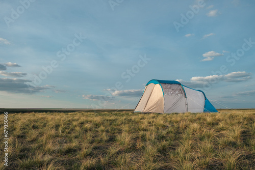 Tent in the steppe against the backdrop of the sunset